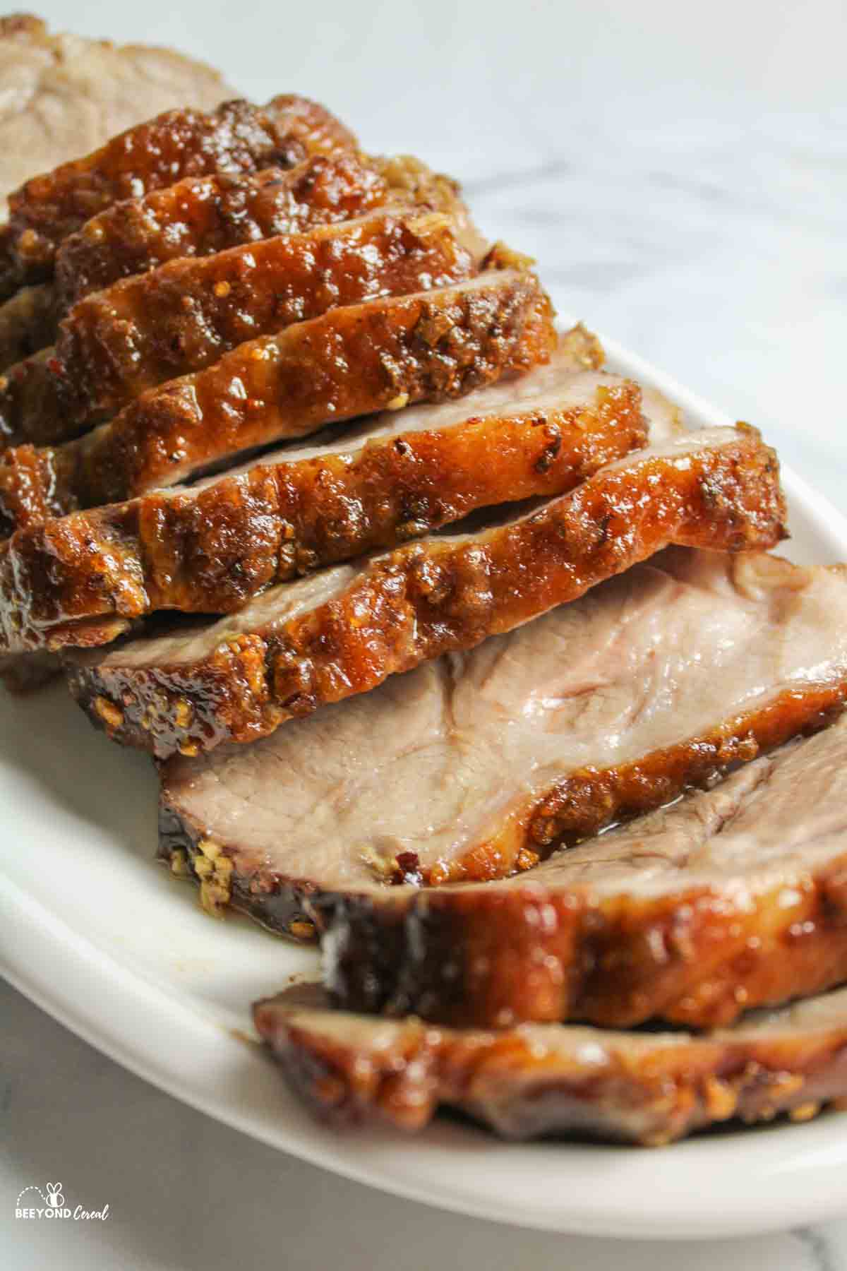 juicy sliced pork roast on a cutting iard