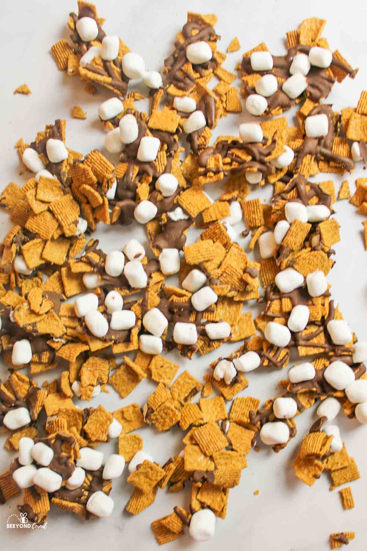 a large scattered assortment of golden graham snack mix