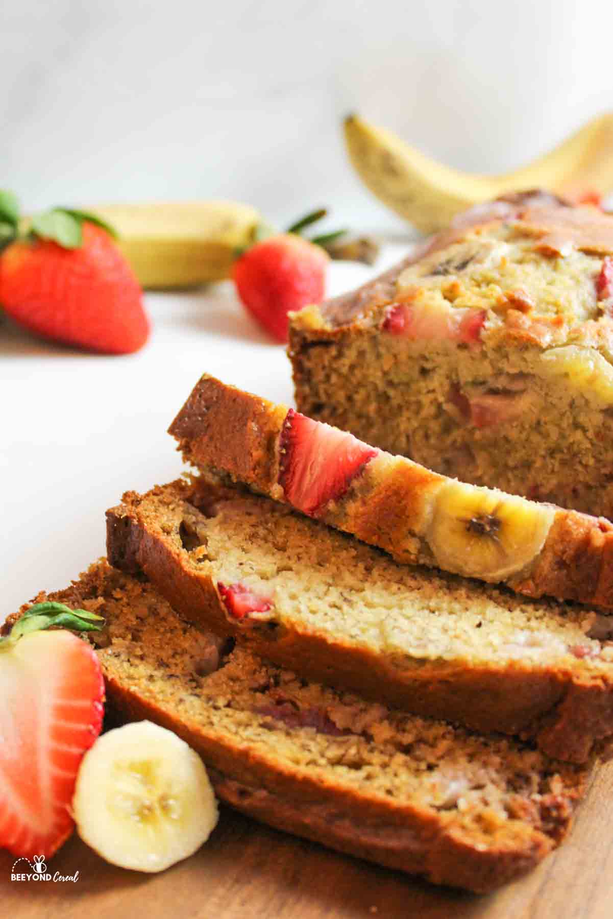 an upclose view of sliced strawberry banana bread