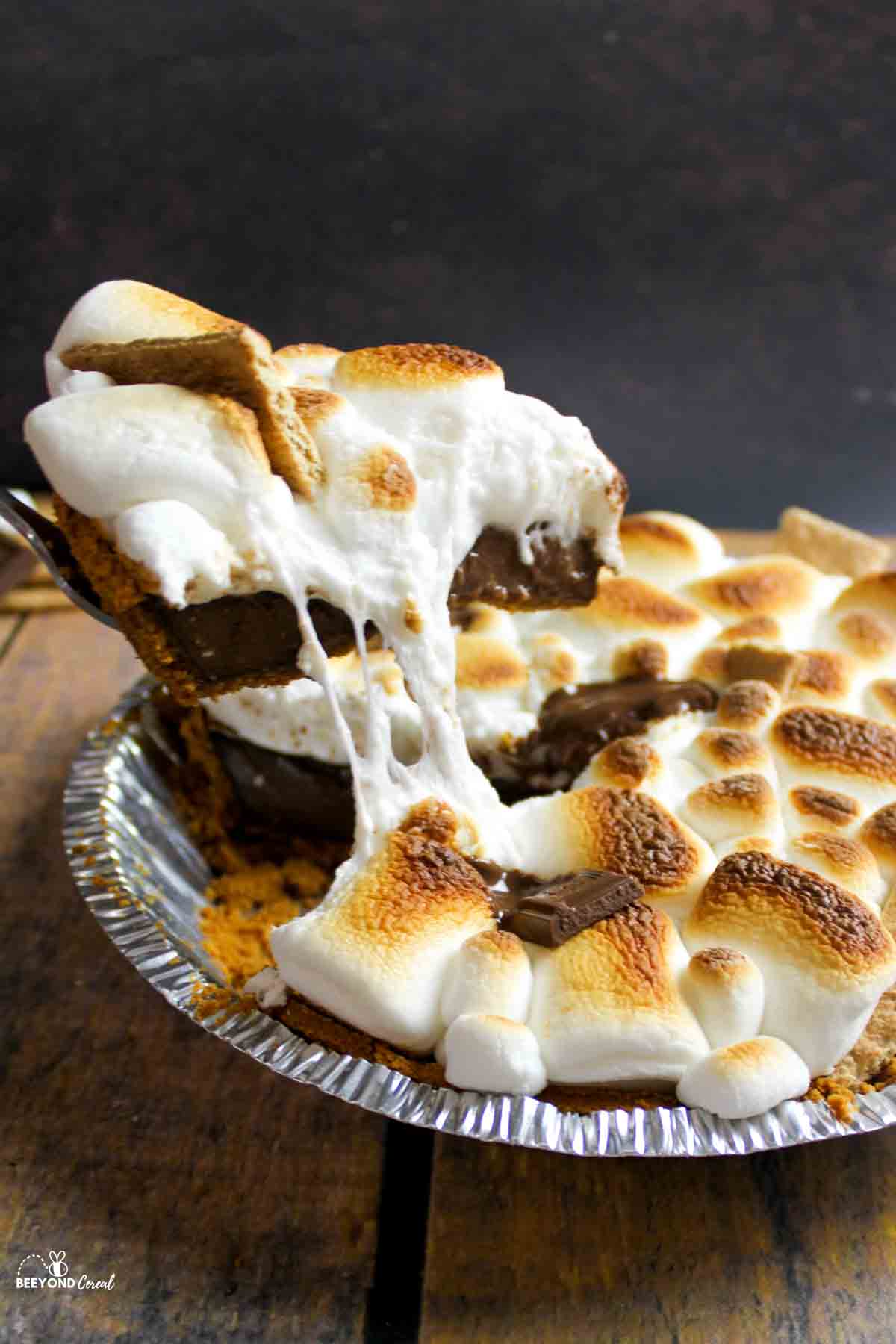 removing a gooey slice of smores pie.