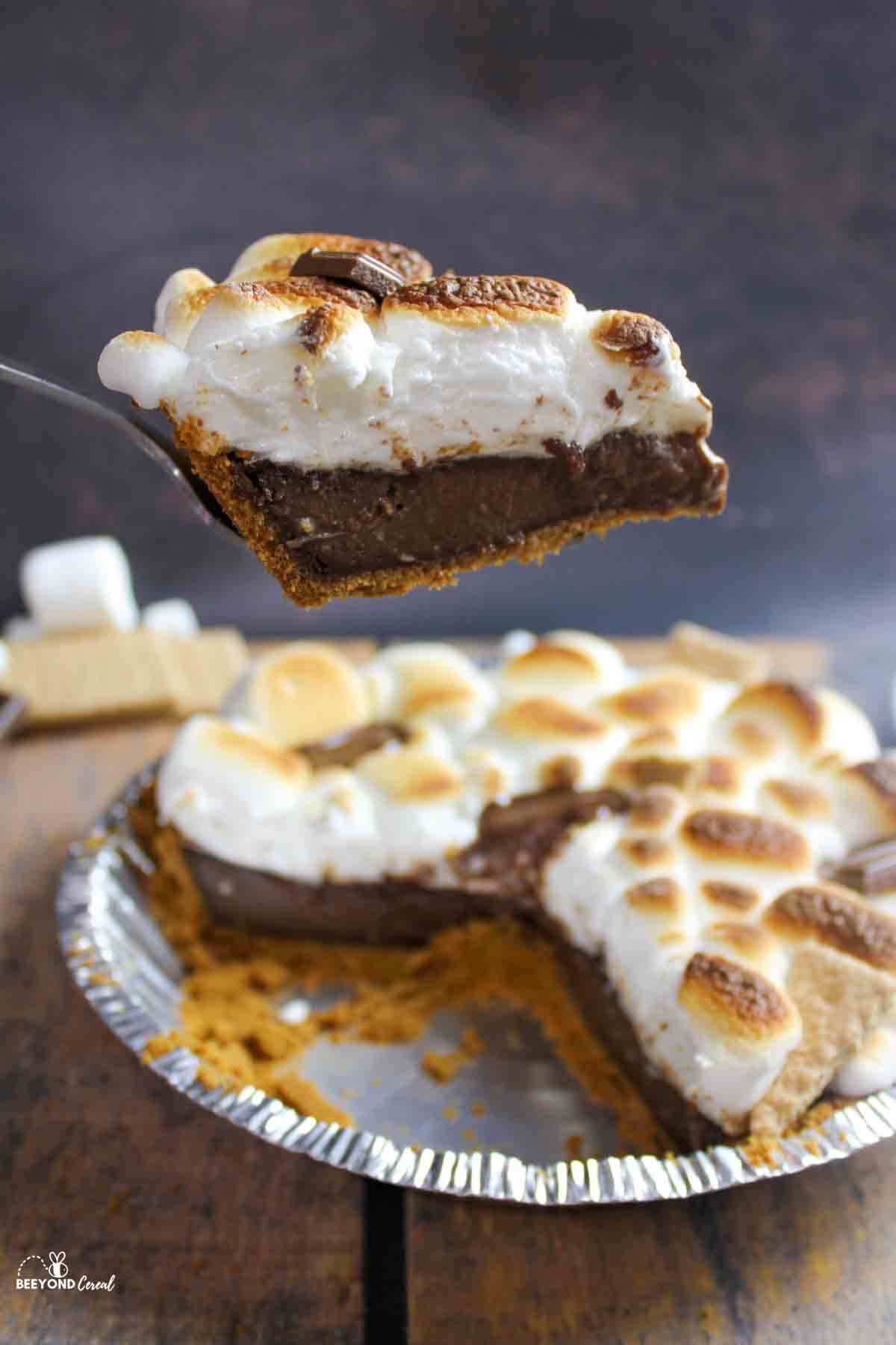 holding up a slice of smores pie