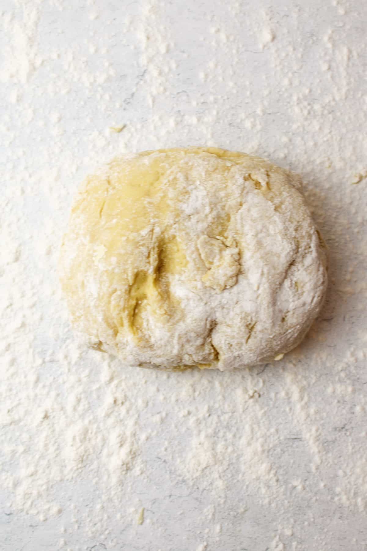 a pile of dough on a floured surface.