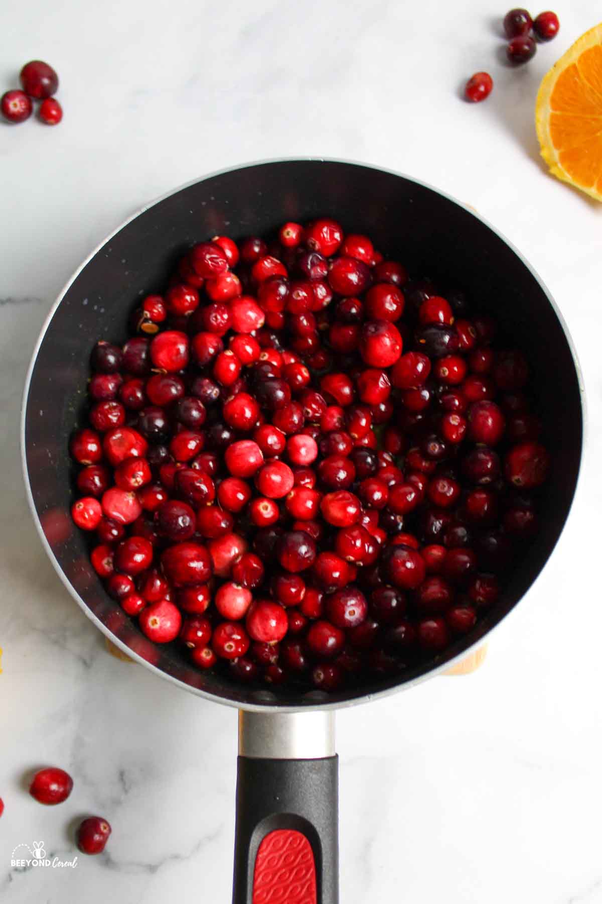 cranberries added to saucepan with orange sauce