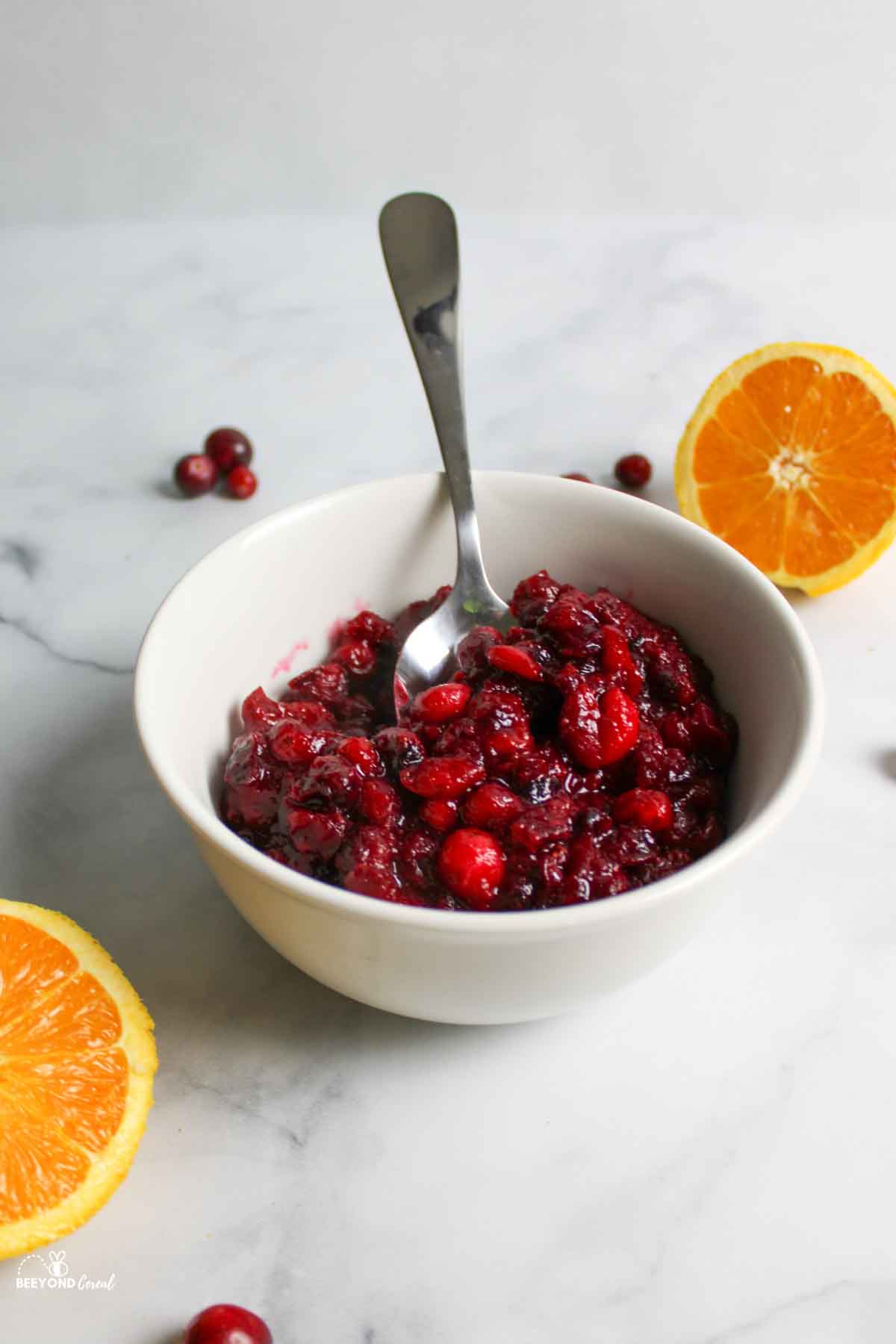 cranberry orange sauce with a spoon sticking in it