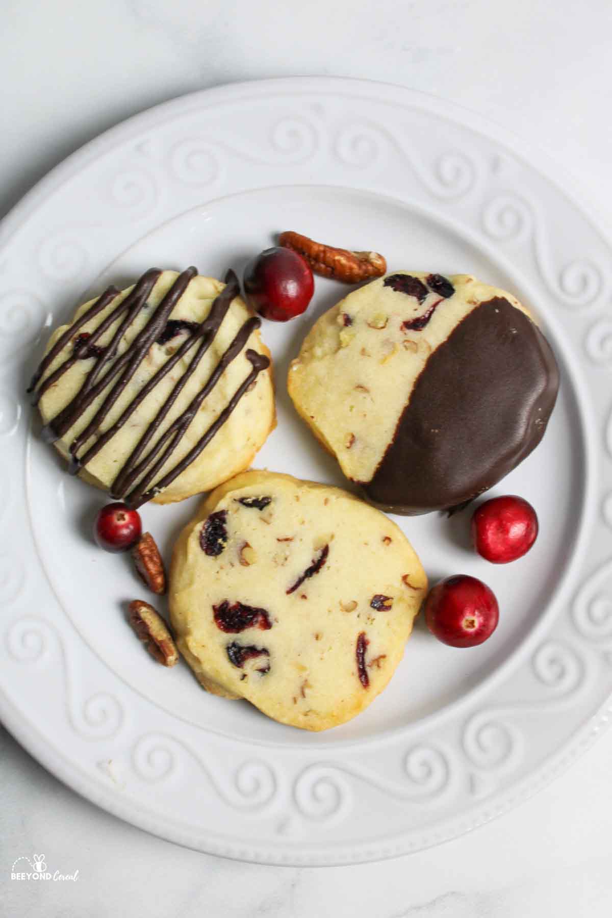 aerial view of cranberry shortbread cookies with whole cranberries and pecans