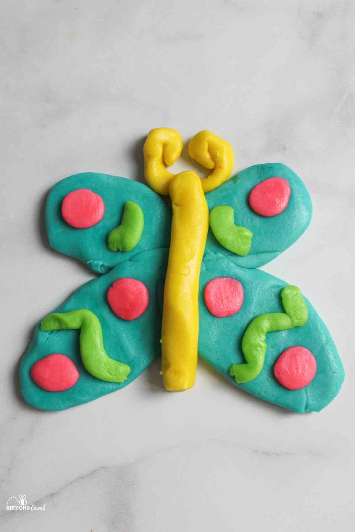 butterfly shaped playdoh cookie ready for baking