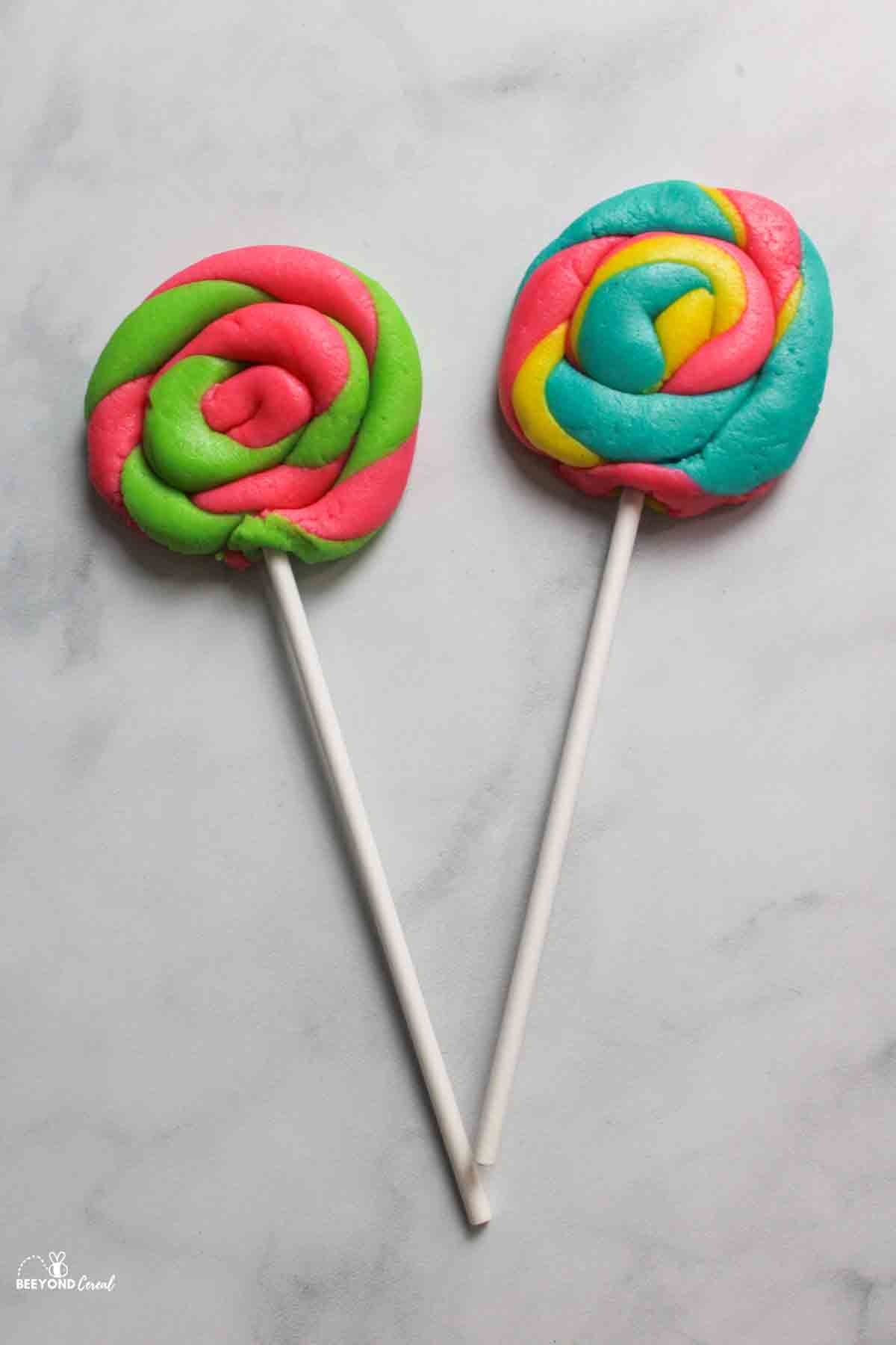 two raw lollipop shaped playdoh cookies.