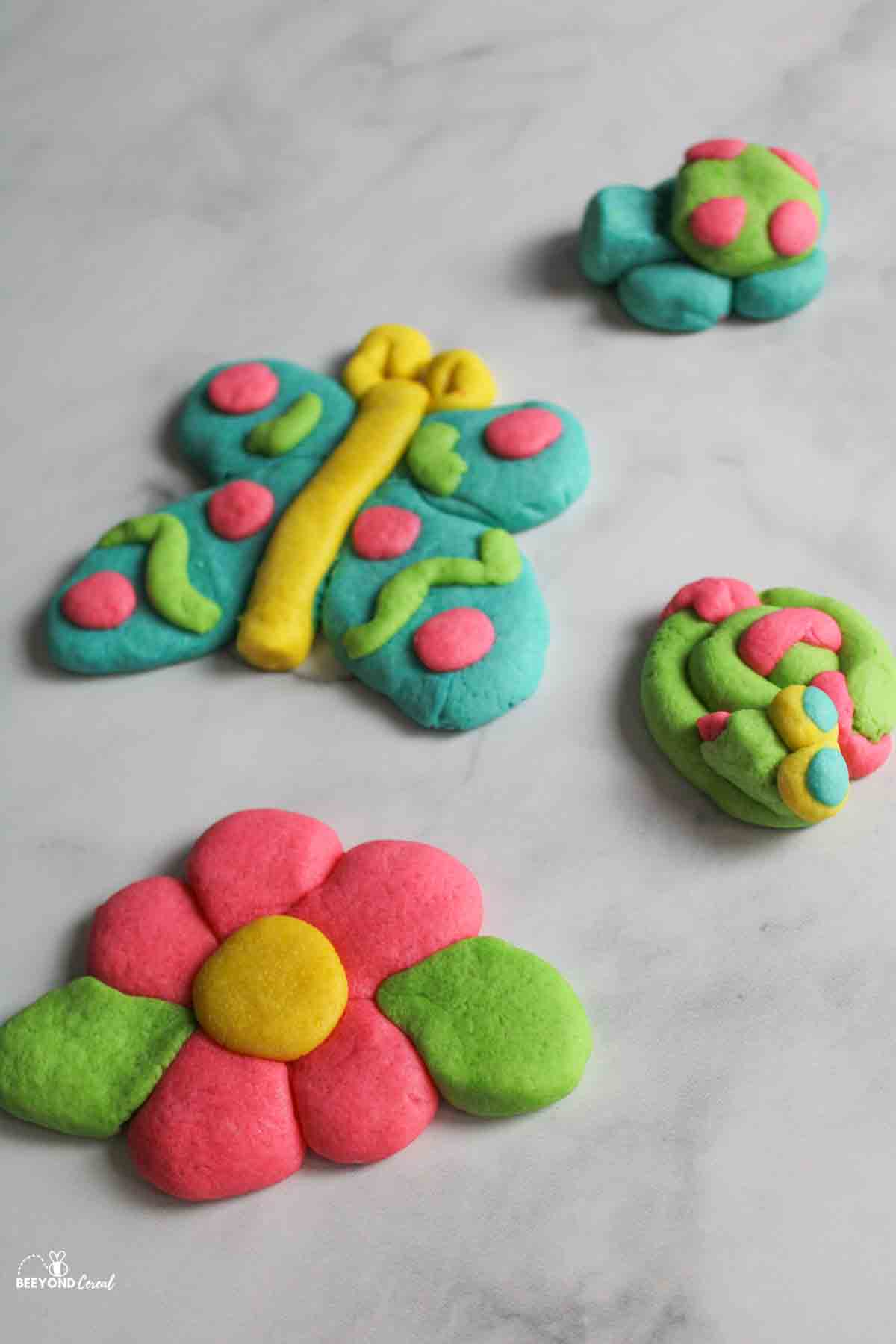 acookie shaped like a butterfly, flower, turtle, and snake