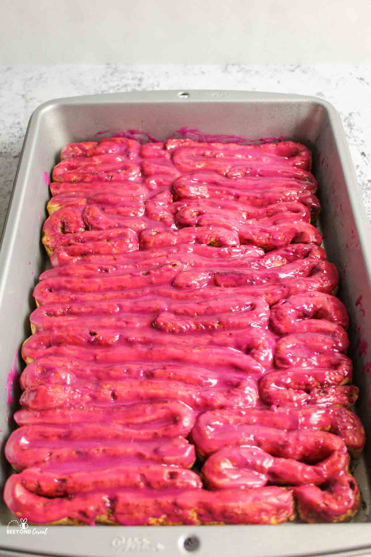 glazed cinnamon roll intestines in a baking dish