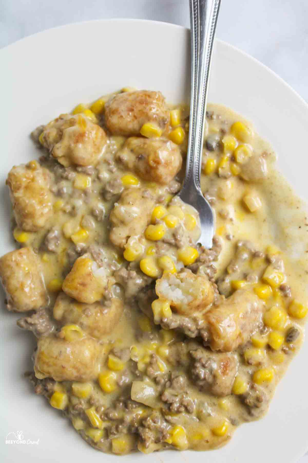 tater tot casserole on a plate with a fork.