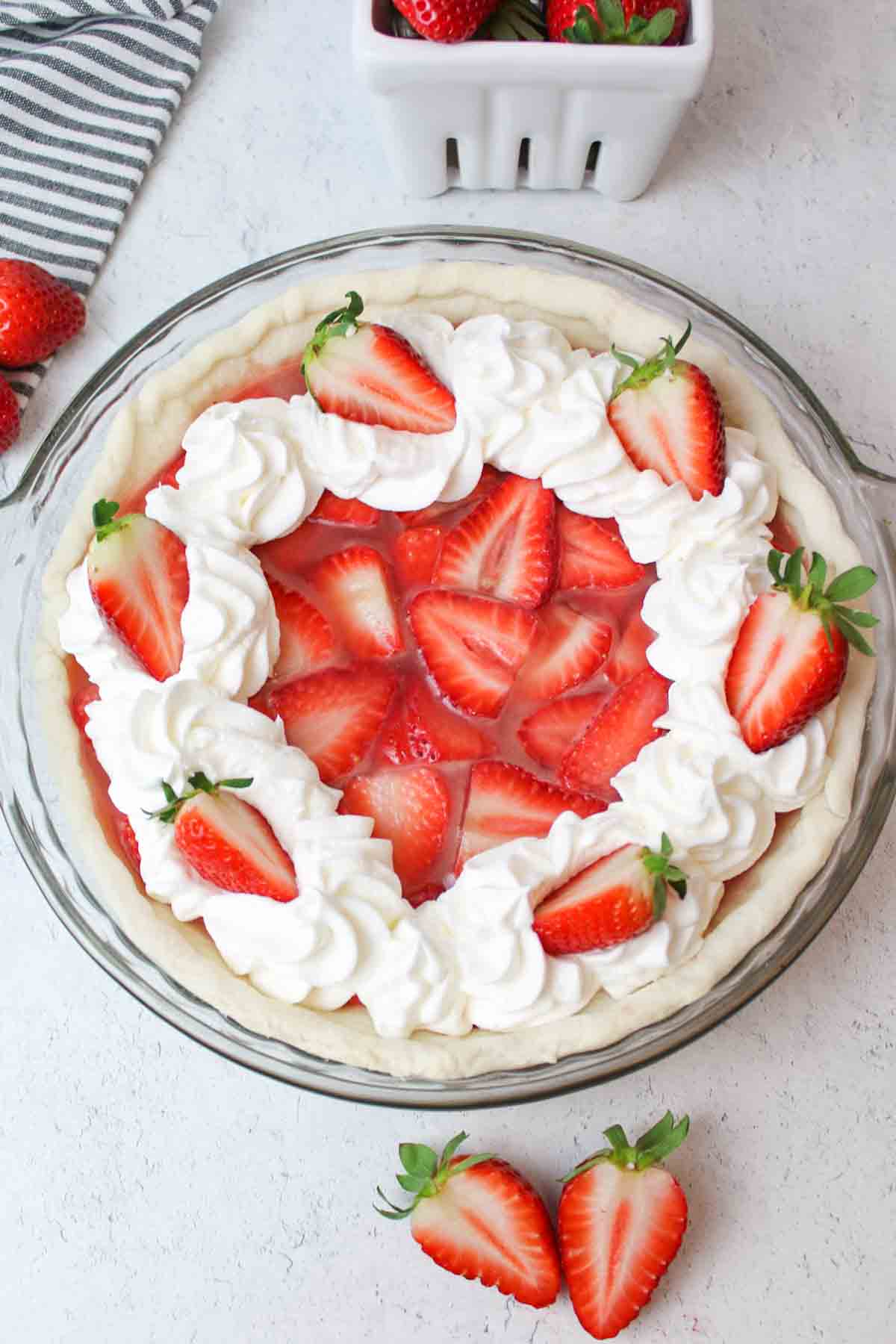 aerial view of whipped cream garnished fresh strawberry pie