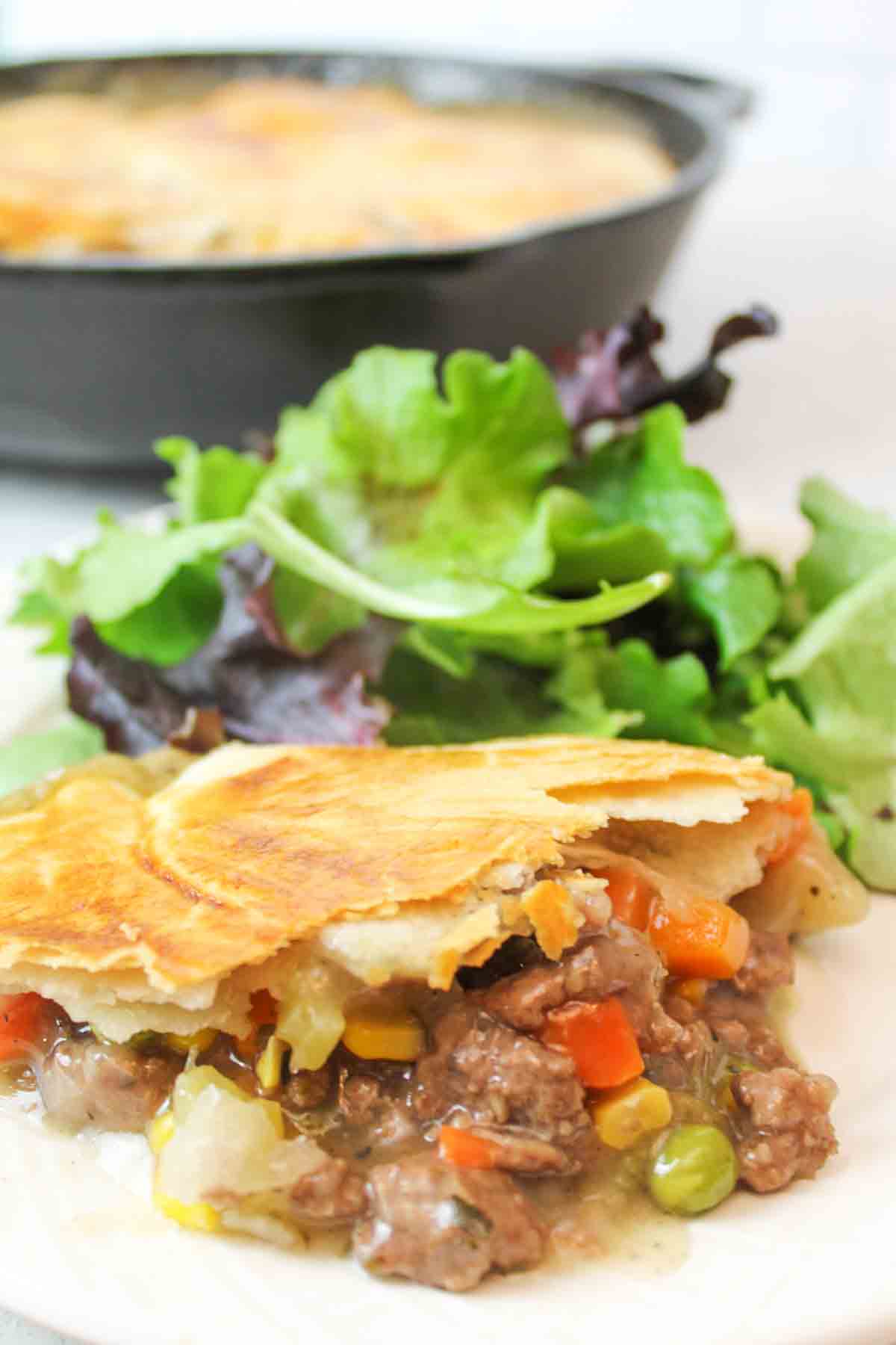 an upclose view of the gravy filled pot pie with ground beef and veggies