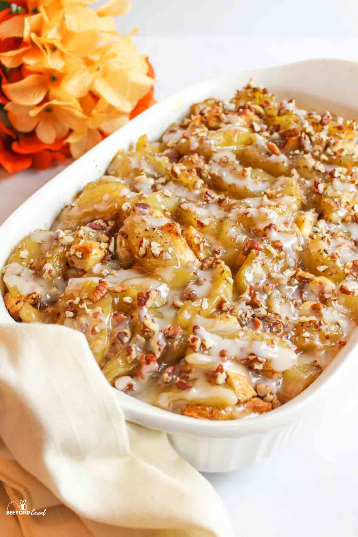 cinnamon roll apple cobbler in a white baking dish.