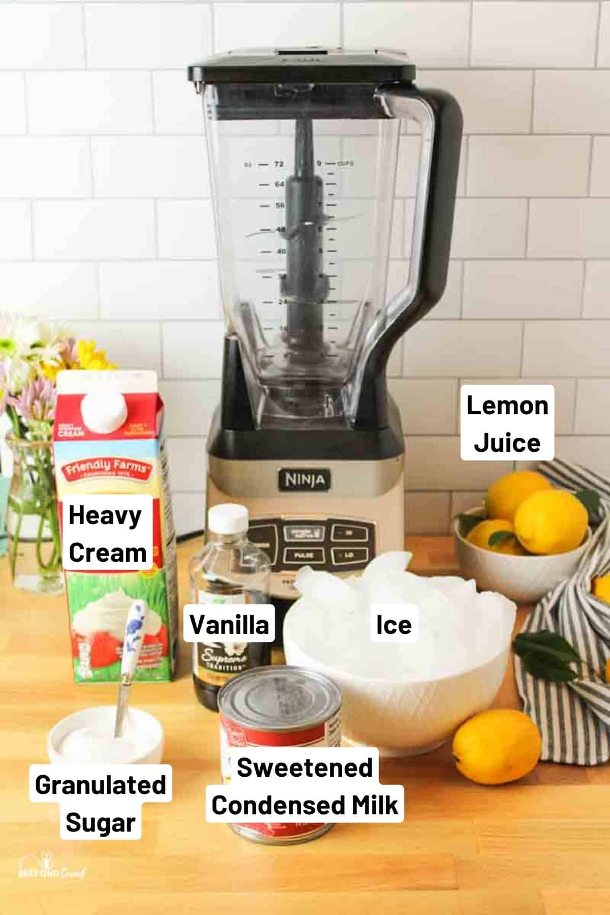 the ingredients needed to make frozen whipped lemonade and a blender