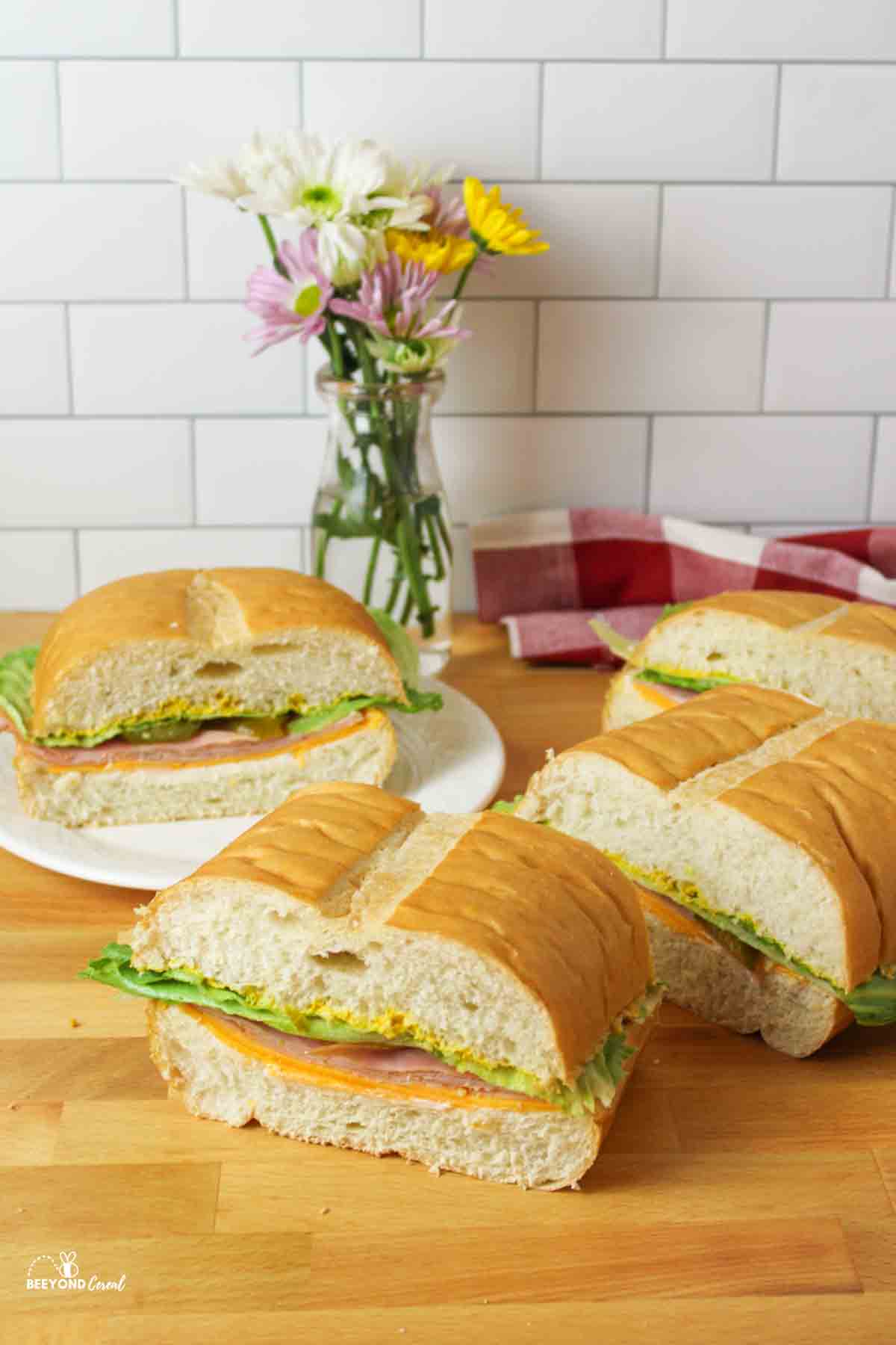 a large sub sandwich that has been served into 4 large slices.