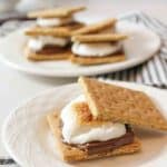 a toasted marshmallow smore with the top graham cracker set off at an angle to show the toasted marshmallow.