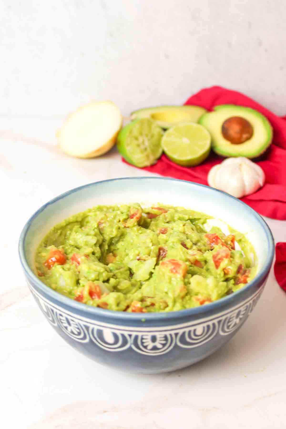 a blue bowl filled with guacamole.