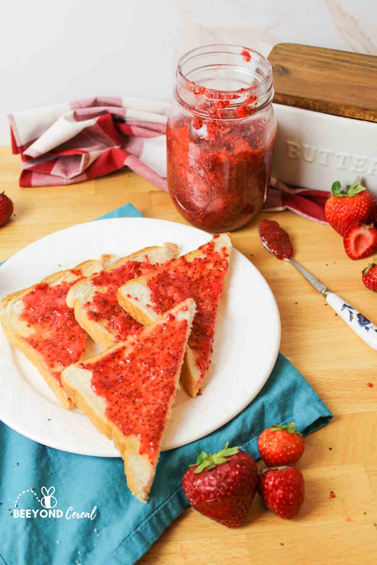 sugar free strawberry jam being used on sliced toast.