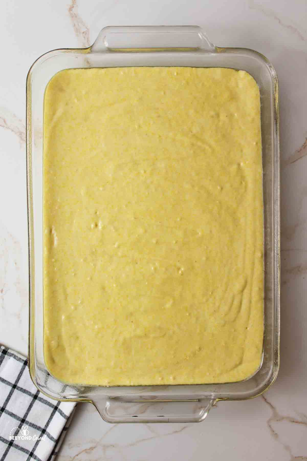 a baking dish filled with cornbread batter.