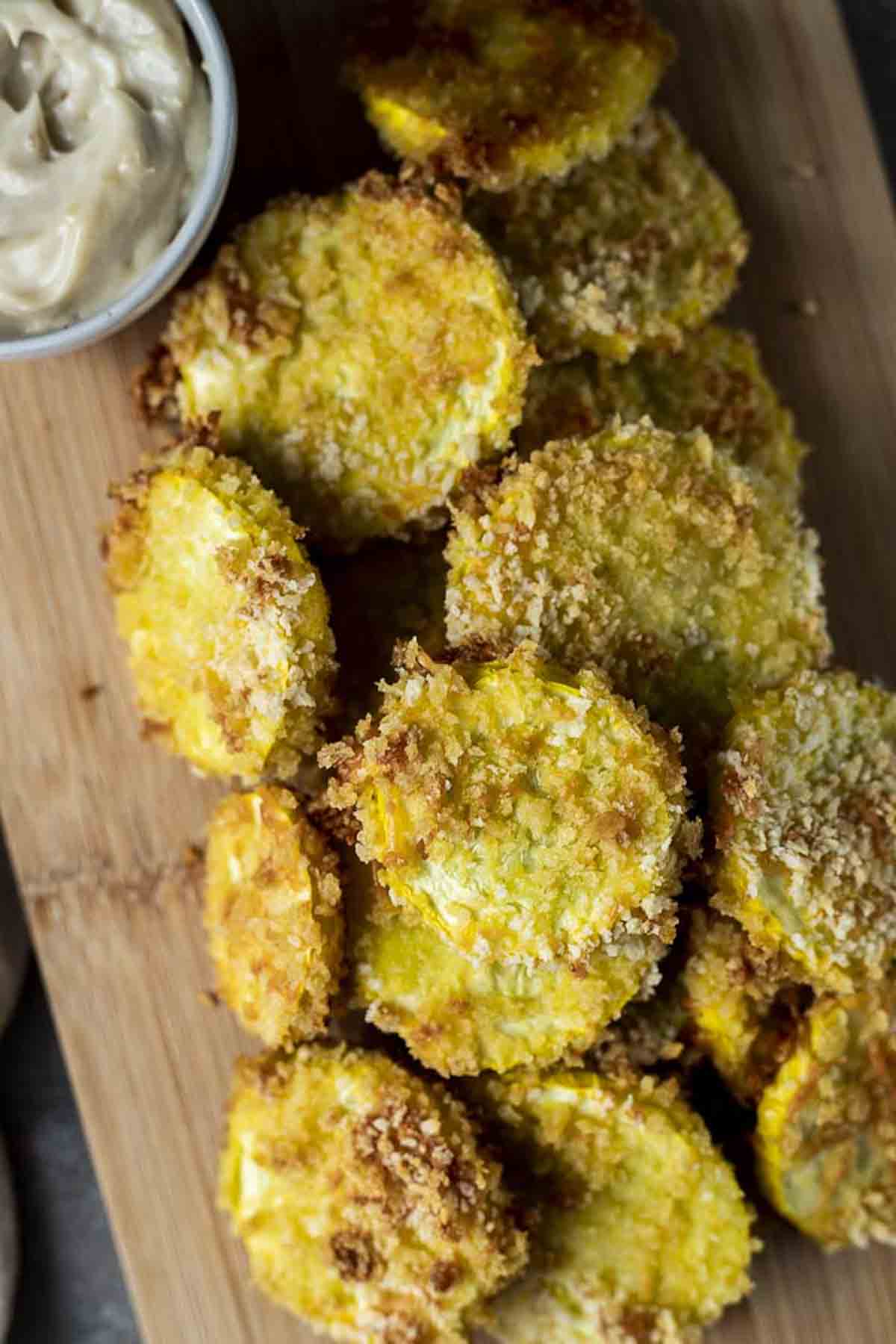 oven fried squash on a wooden cutting board
