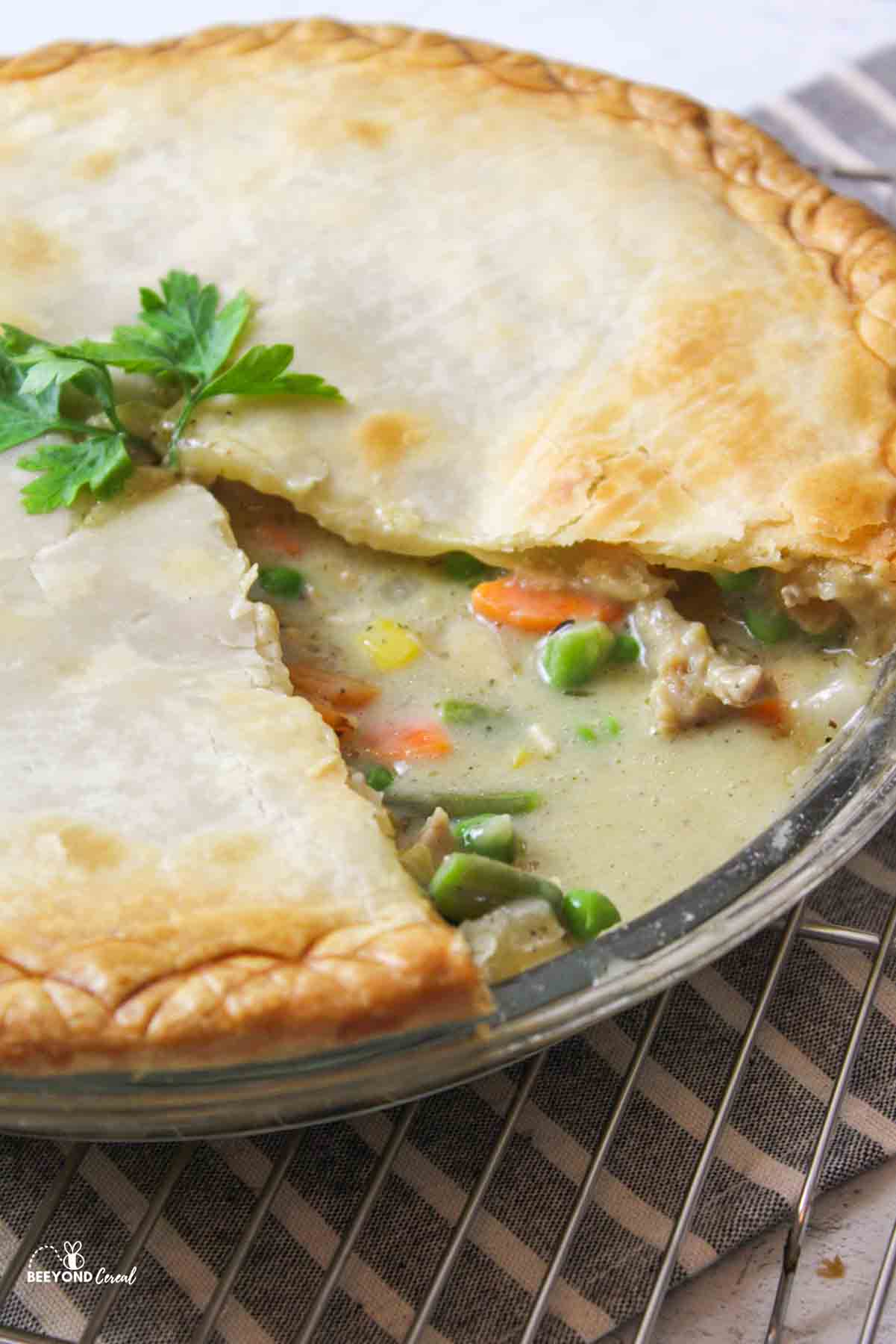 an upclose view of a sliced chicken pot pie with the top crust removed to reveal baked insides