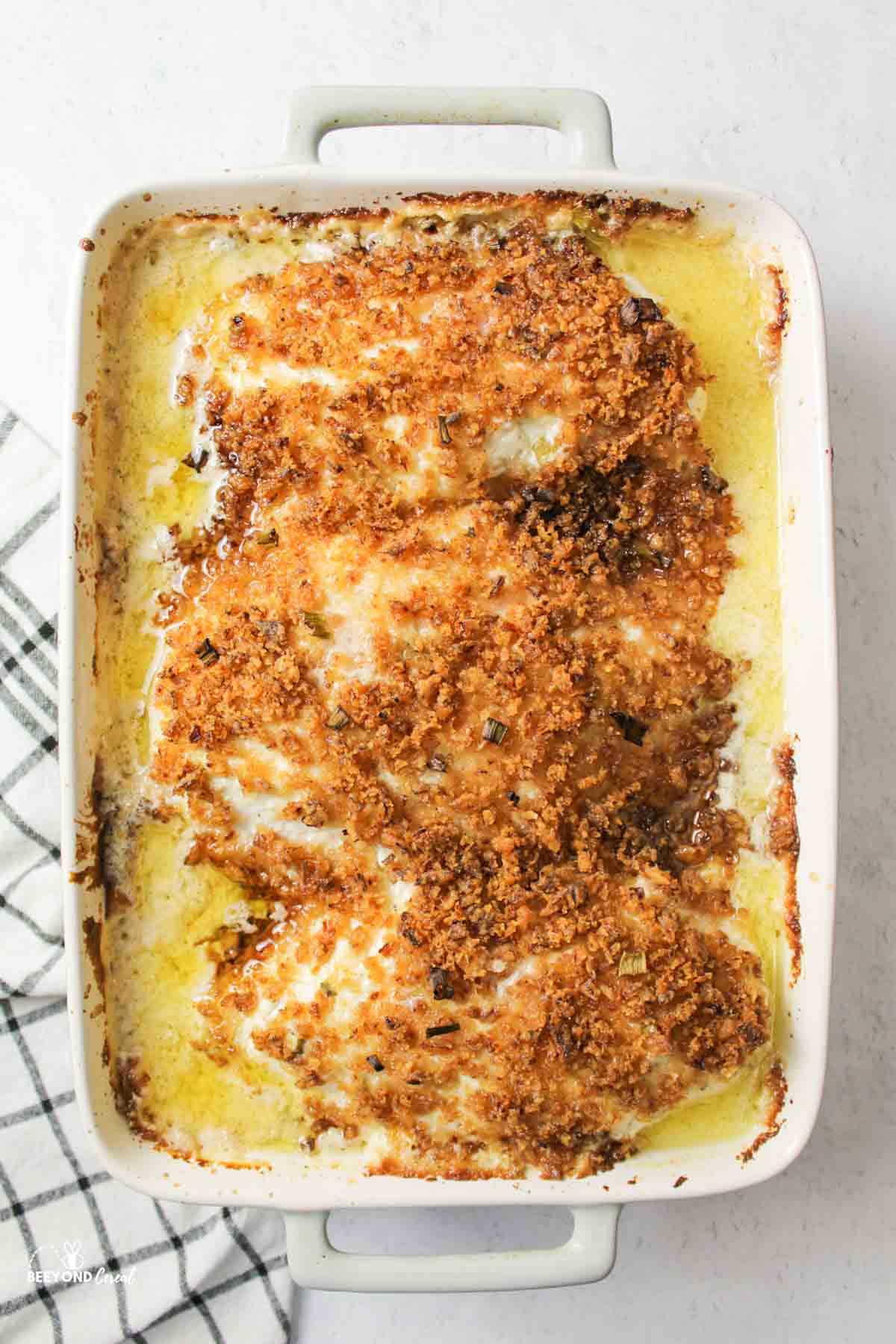 a baked crispy sour cream onion chicken in baking dish