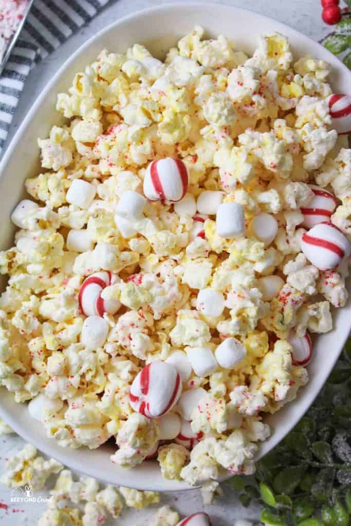 a close aerial view of peppermint popcorn in a white oval dish