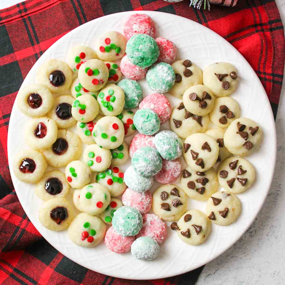 a white plate topped with christmas cookies made elf sized and tiny.