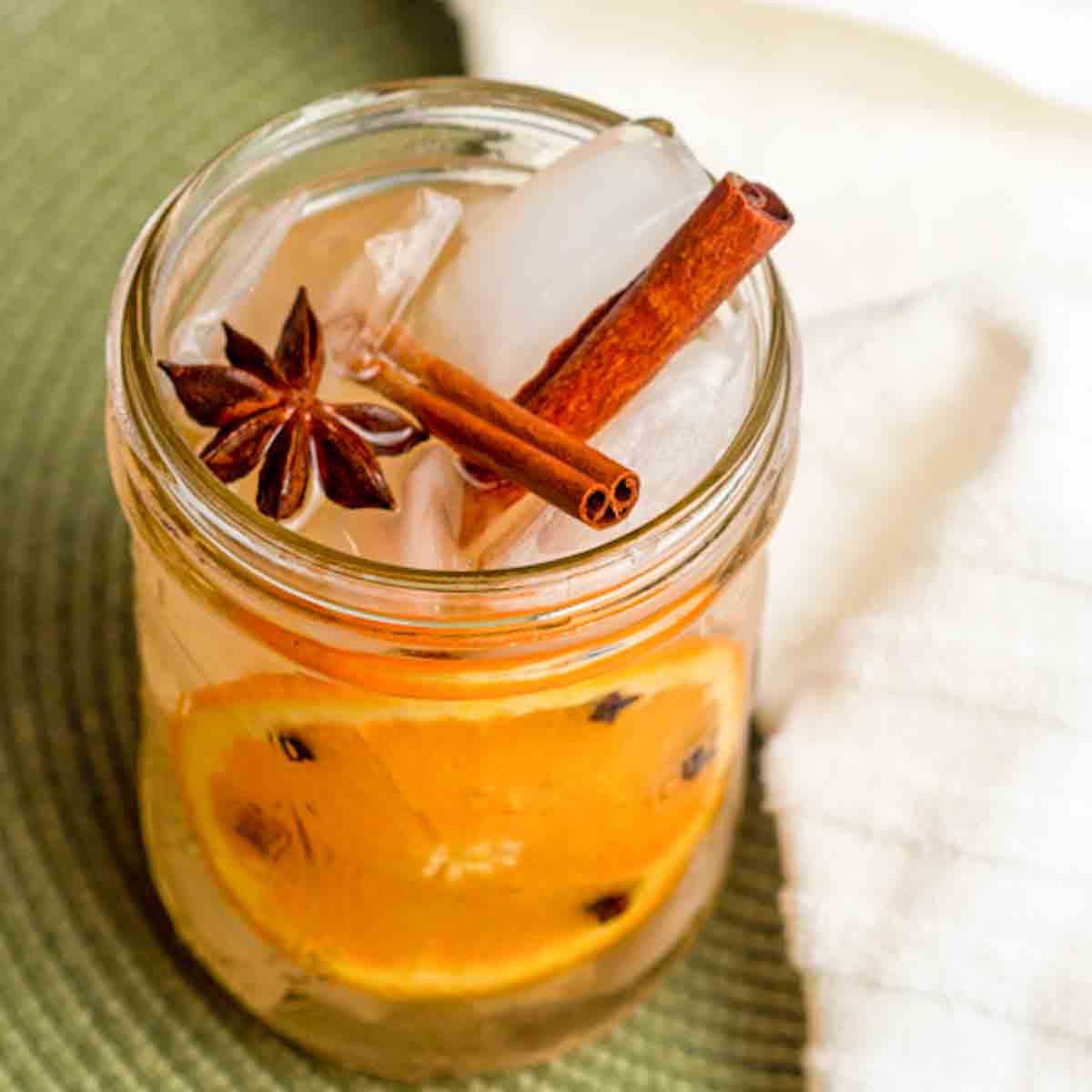 a glass jar filled with spicd orange ginger ale.