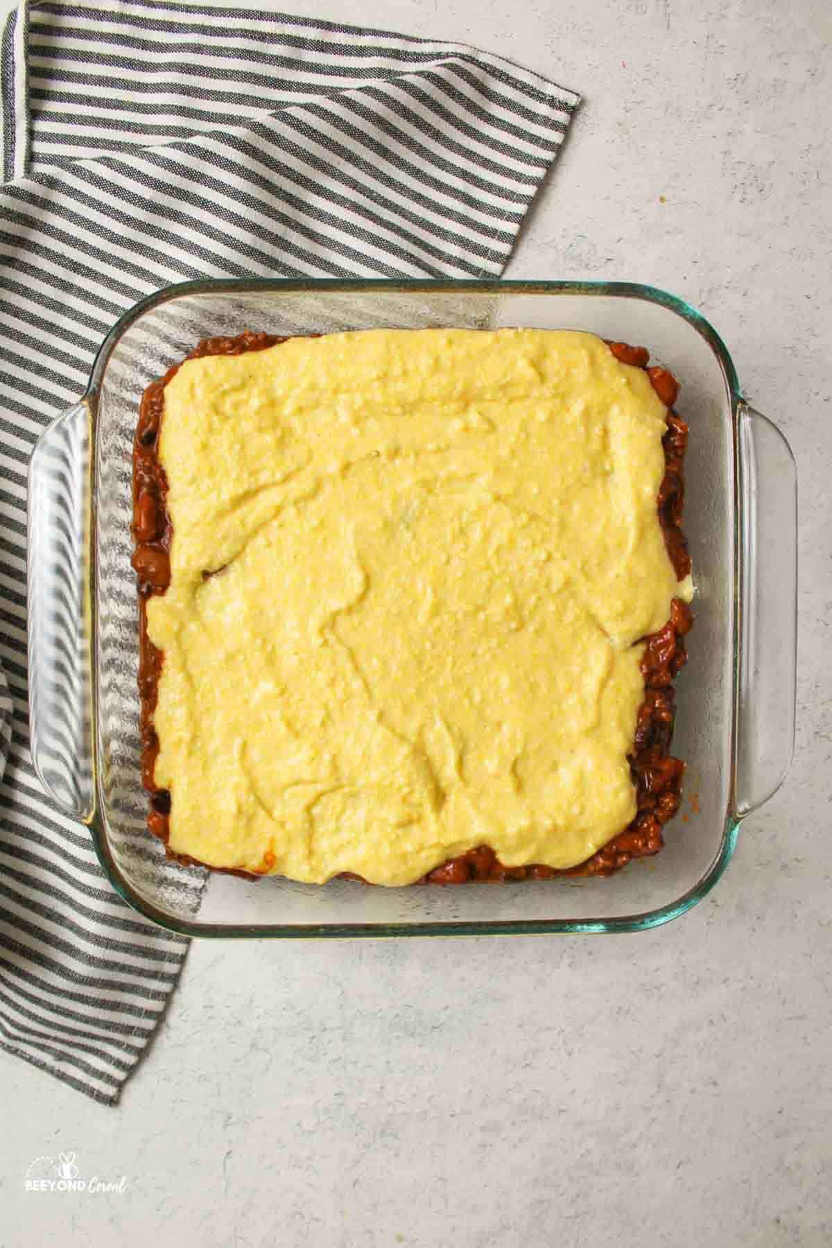 aerial view of tamale pie unbaked and in a square baking dish