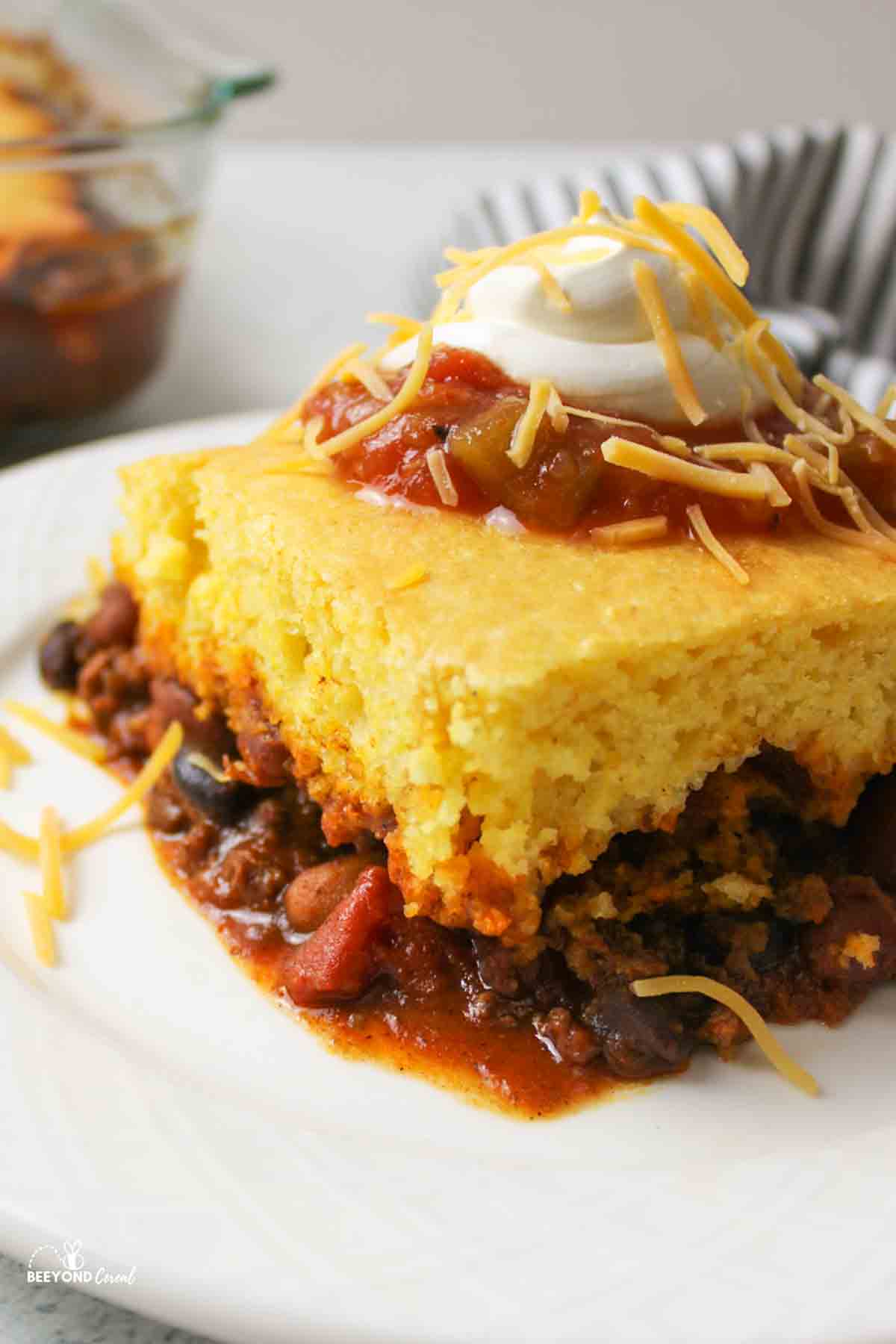 tamale pie on a plate with toppings.