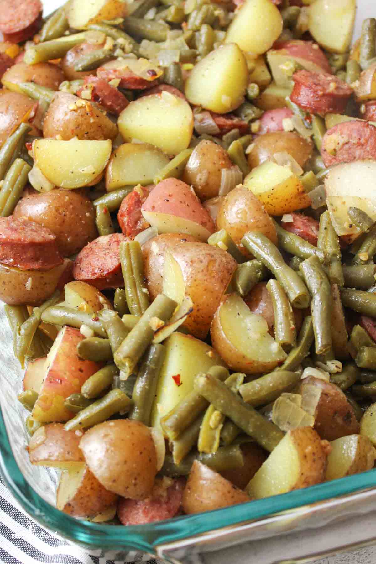 sausage green bean potato casserole in a glass baking dish.