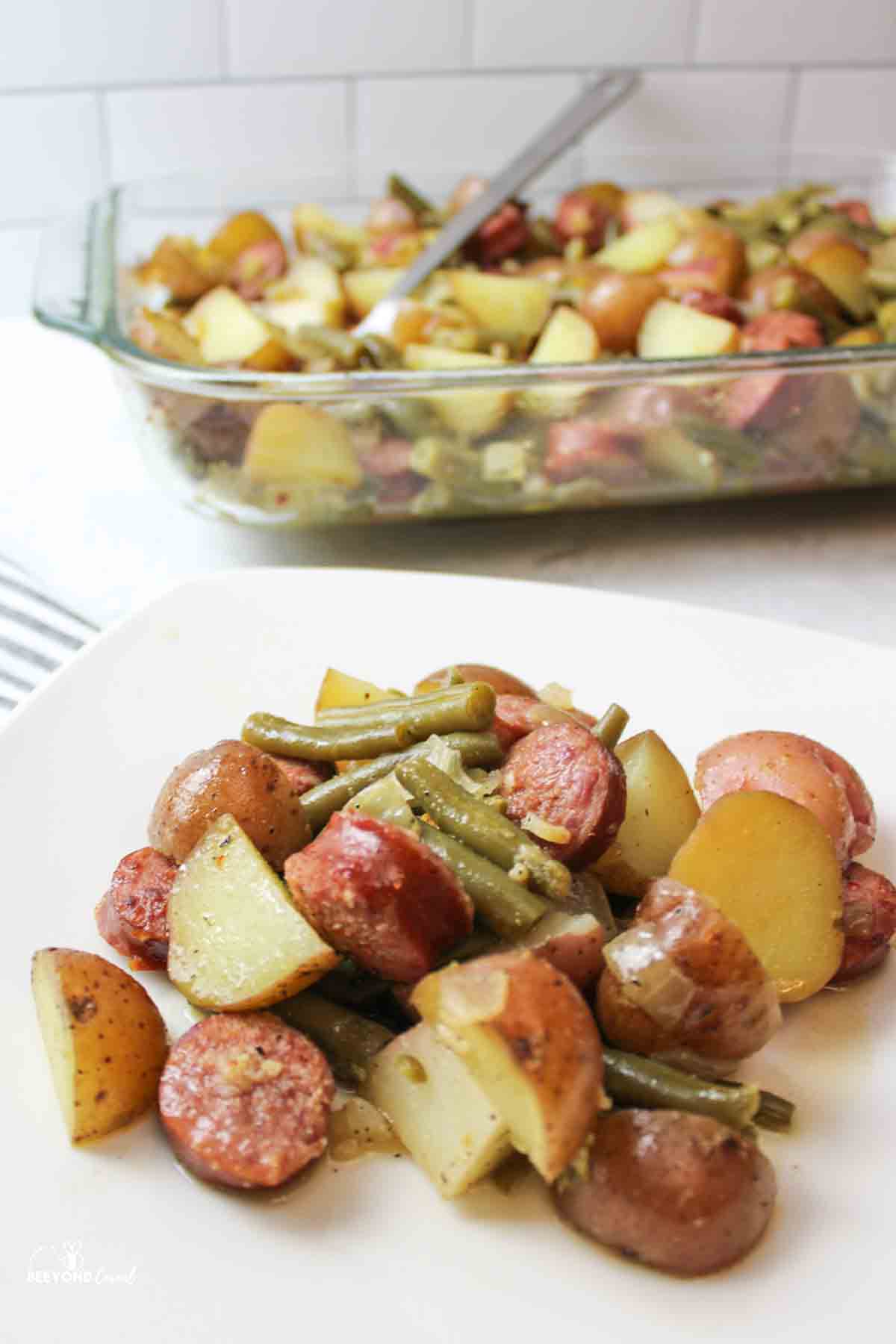 serving of sausage potato green bean casserole on a plate.