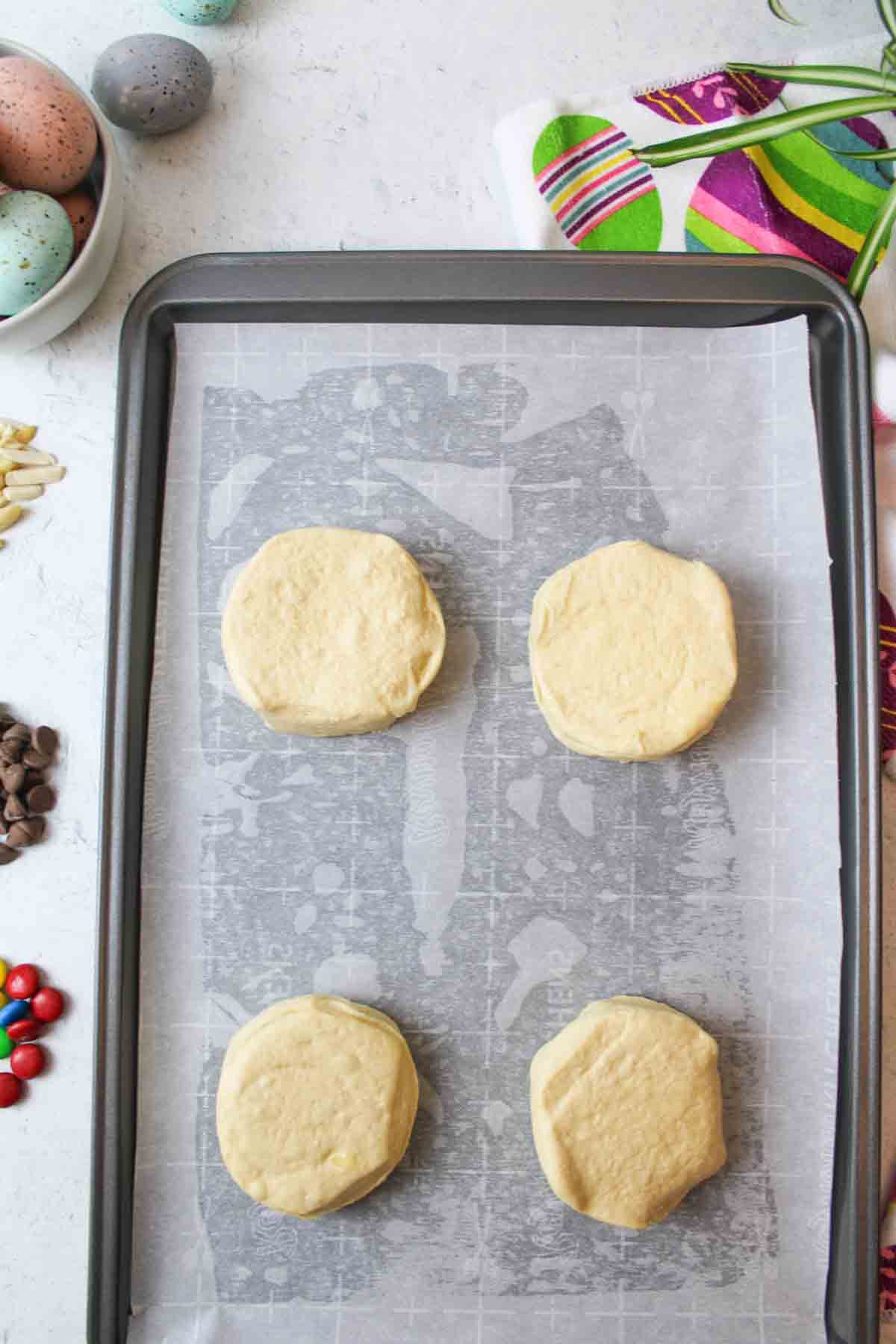 4 whole biscuits on a parchment lined baking sheet.