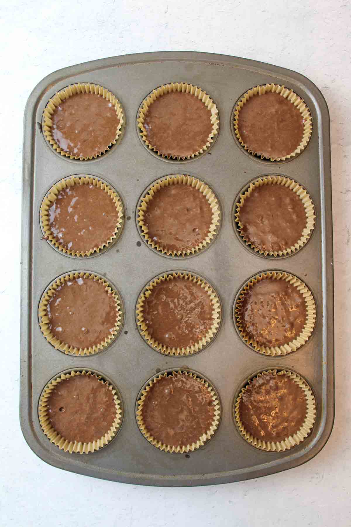 chocolate cupcake batter in cupcake liners