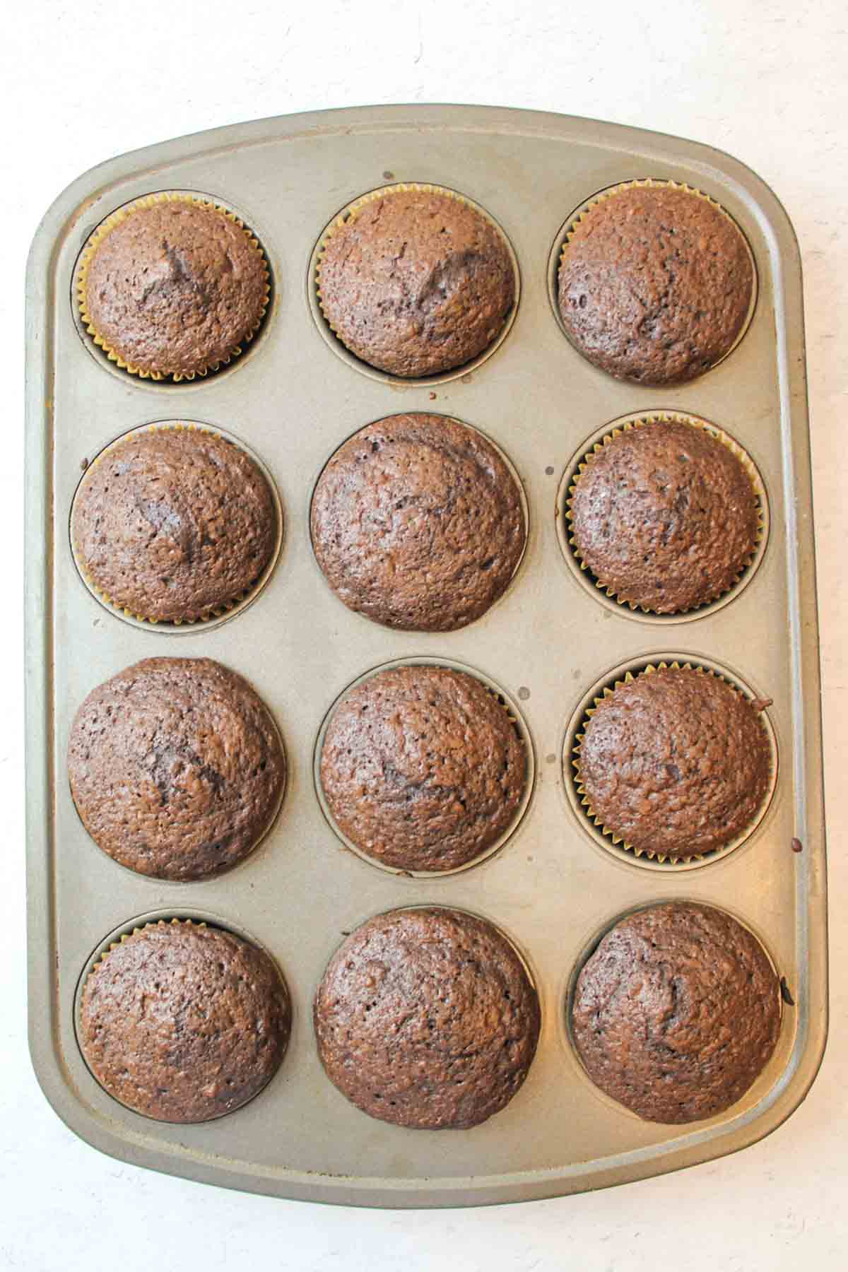 baked chocolate cupcakes in a muffin tin