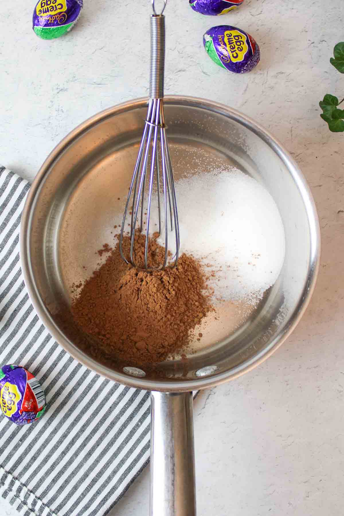 metal pot with sugar and cocoa powder inside.