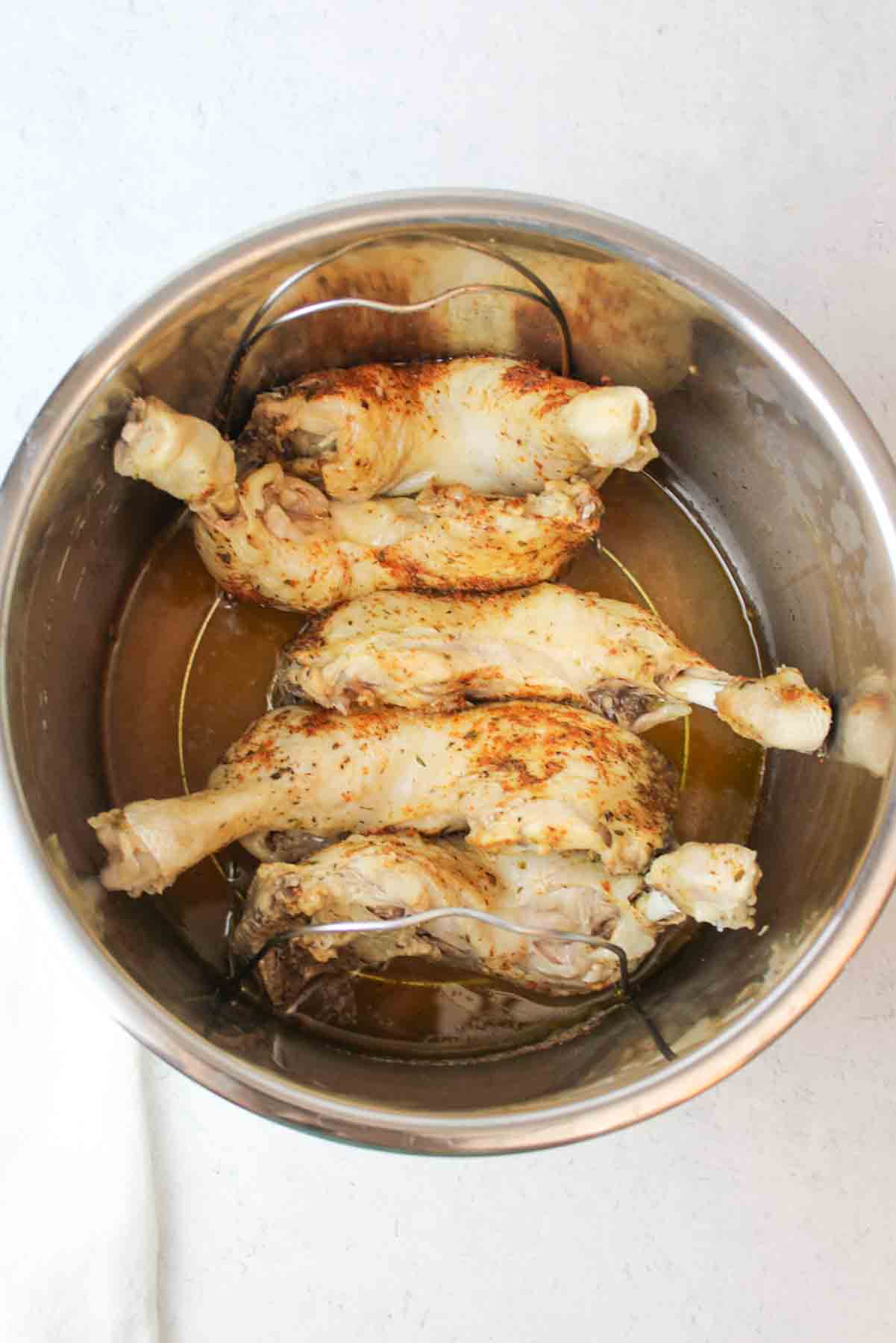 cooked chicken quarters in an instant pot liner.
