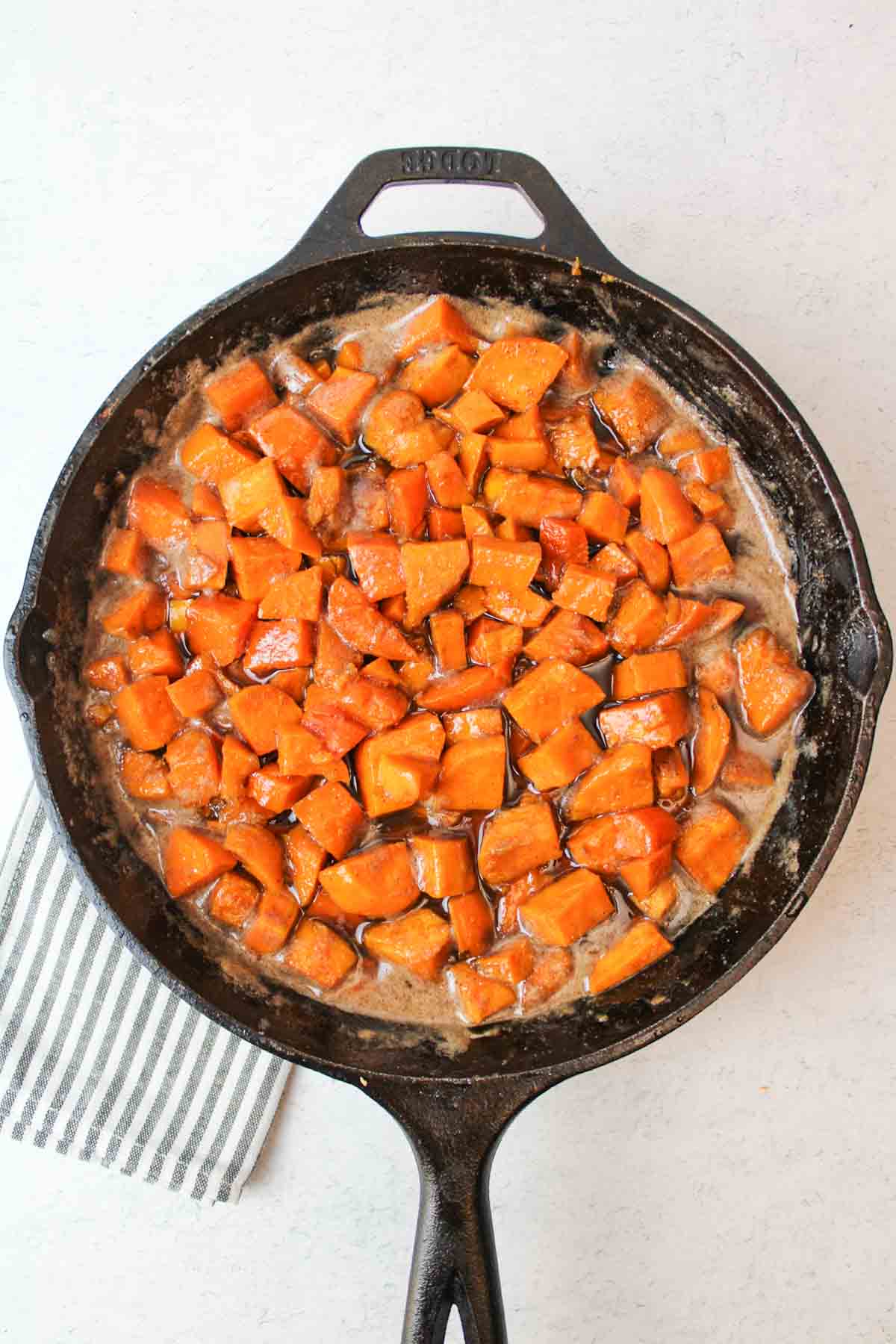 candied stove top sweet potatoes in a cast iron skillet