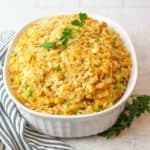 mac and cheesre tua casserole in a casserole dish with parsley on top
