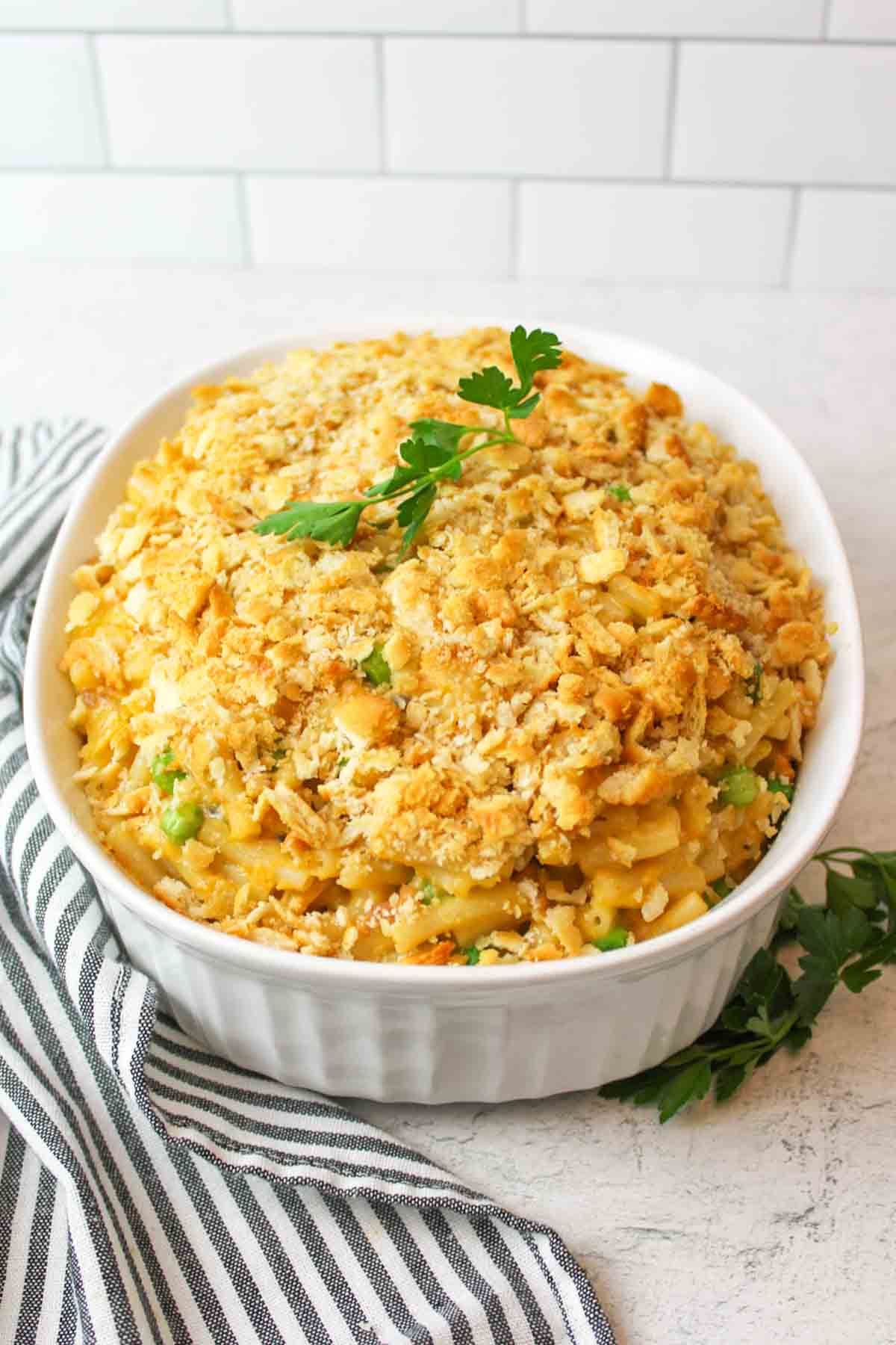 fresh parsley with a dish of mac and cheese tuna casserole