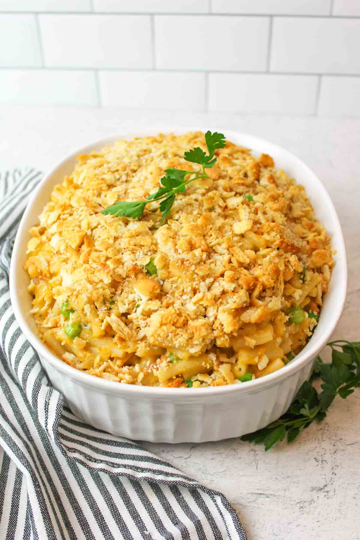 fresh parsley with a dish of mac and cheese tuna casserole.