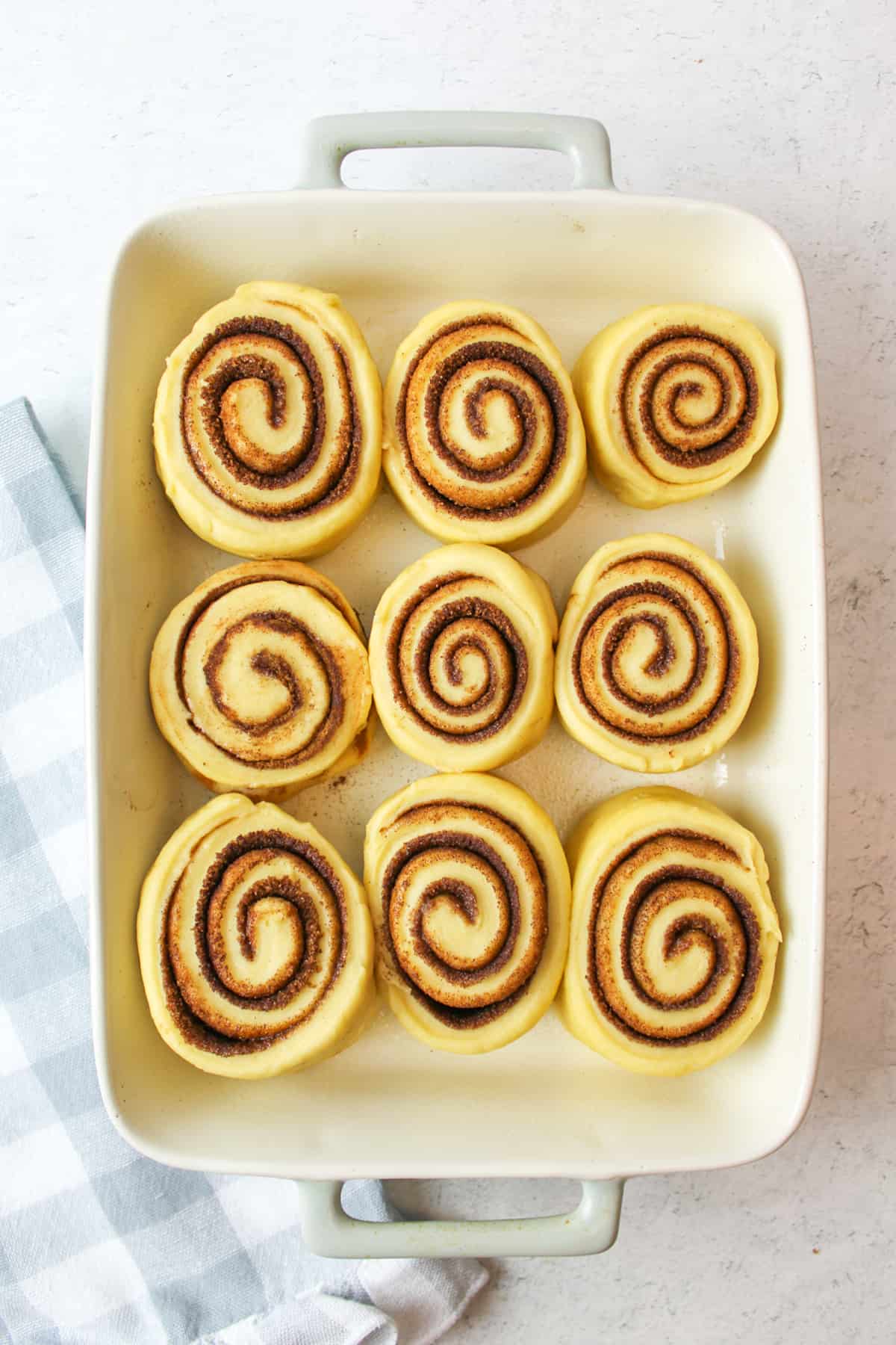 9 cut cinnamon rolls in a baking dish