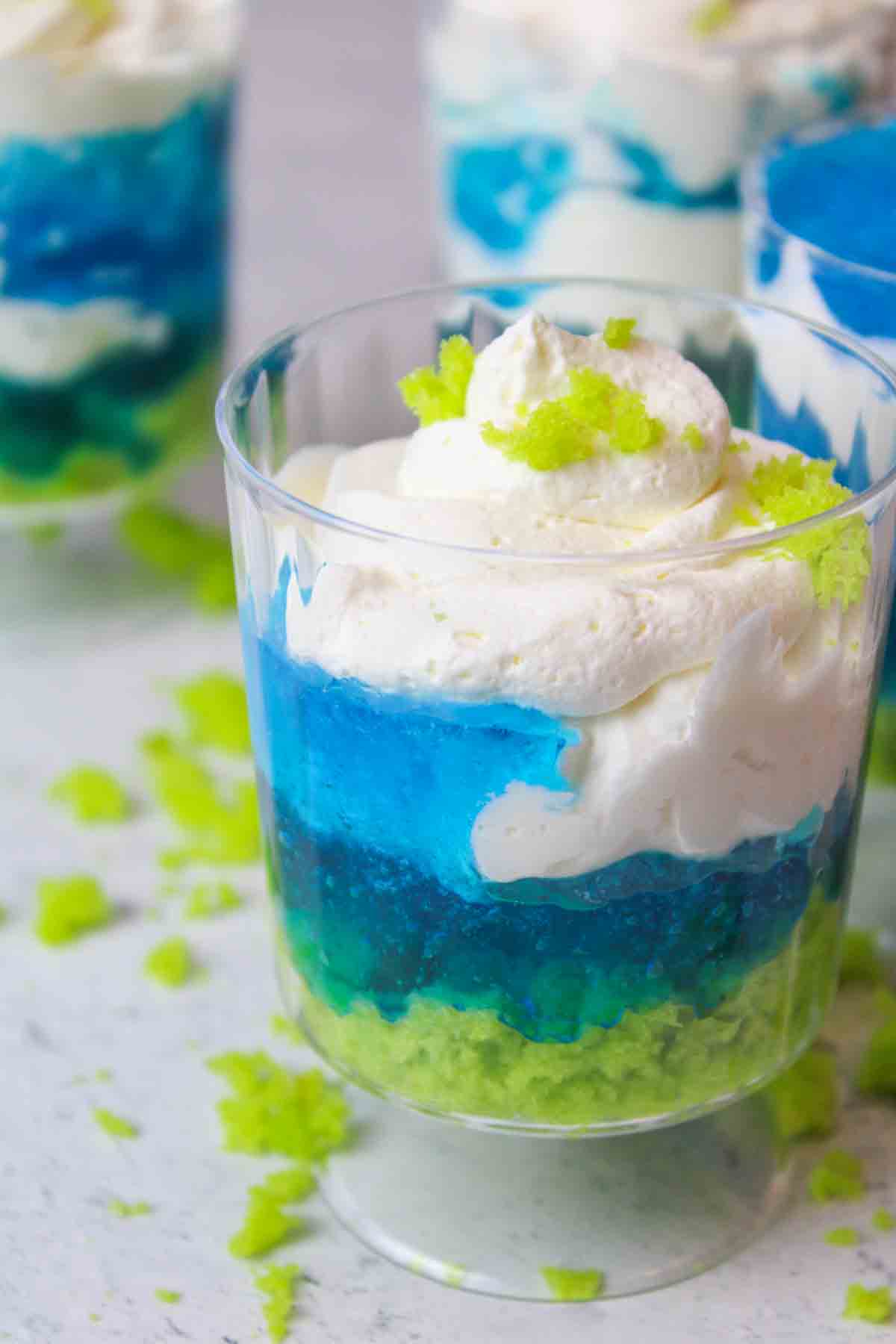 a green, blue, and white earth day parfait in a clear cup