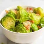 Brussel Sprouts and Bacon in a white bowl.
