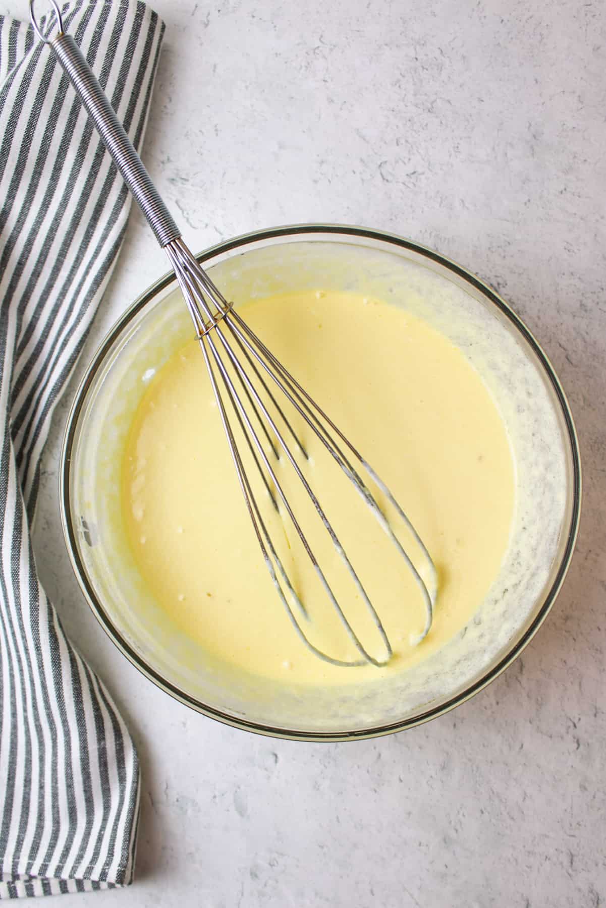 combined wet ingredients in a mixing bowl with a whisk
