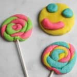 play doh cookies shaped into lollipops and a smily face.