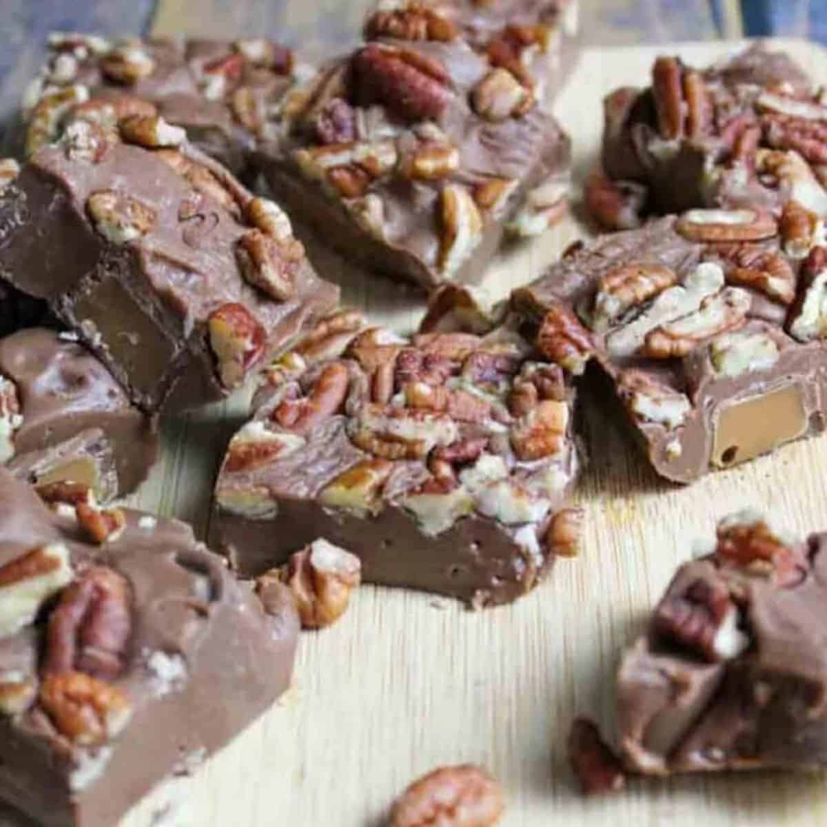 Rolo Turtle Fudge squares on a wooden surface.