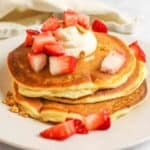 strawberry cheesecake pancakes with strawberry chunks on top.