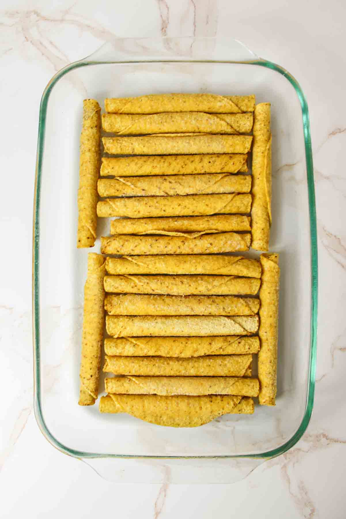 frozen taquitos in a 9x13 baking dish